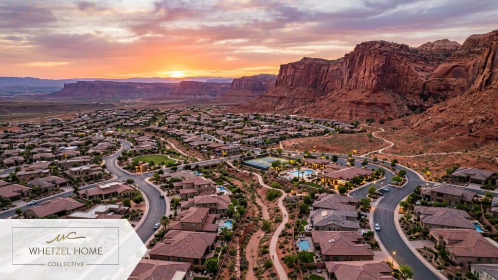 An expansive aerial view of a master-planned residential community nestled against dramatic red sandstone cliffs, modern homes with tile roofs, paved walking trails winding through the neighborhood, sunset lighting casting warm orange and pink hues, highly detailed, photorealistic drone shot