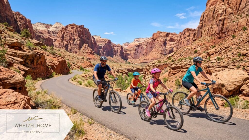 A vibrant, high-quality photograph of a family riding bicycles on a smooth paved trail winding through a stunning red rock canyon, bright sunny day, clear blue skies, dynamic action shot, natural lighting, photorealistic.