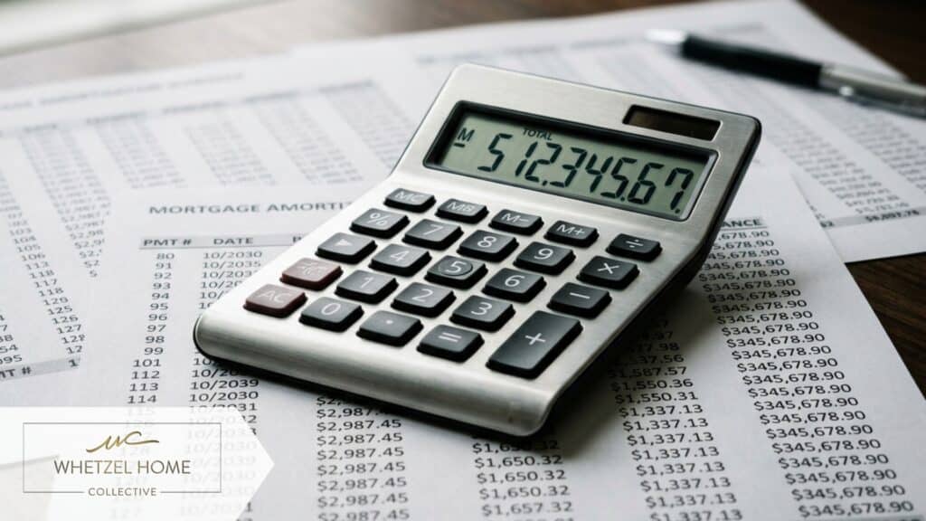 A close-up, high-detail macro shot of a sleek silver calculator resting on top of printed financial spreadsheets showing mortgage amortization schedules. Soft diffused lighting, professional business aesthetic, shallow depth of field focusing on the numbers.