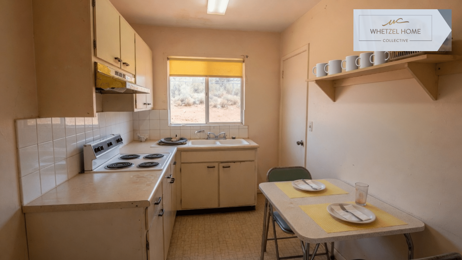 A modest kitchen with a table set for two