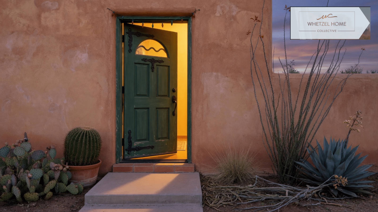 Southwestern entry door open at dusk with desert plants